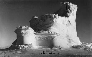 A member of the Terra Nova Expedition (or British Antarctic Exploration team) travels by dogsled in front of a weathered iceberg, circa 1910 or 1911. A member of the Terra Nova Expedition (or British Antarctic Exploration team) travels by dogsled in front of a weathered iceberg, circa 1910 or 1911.