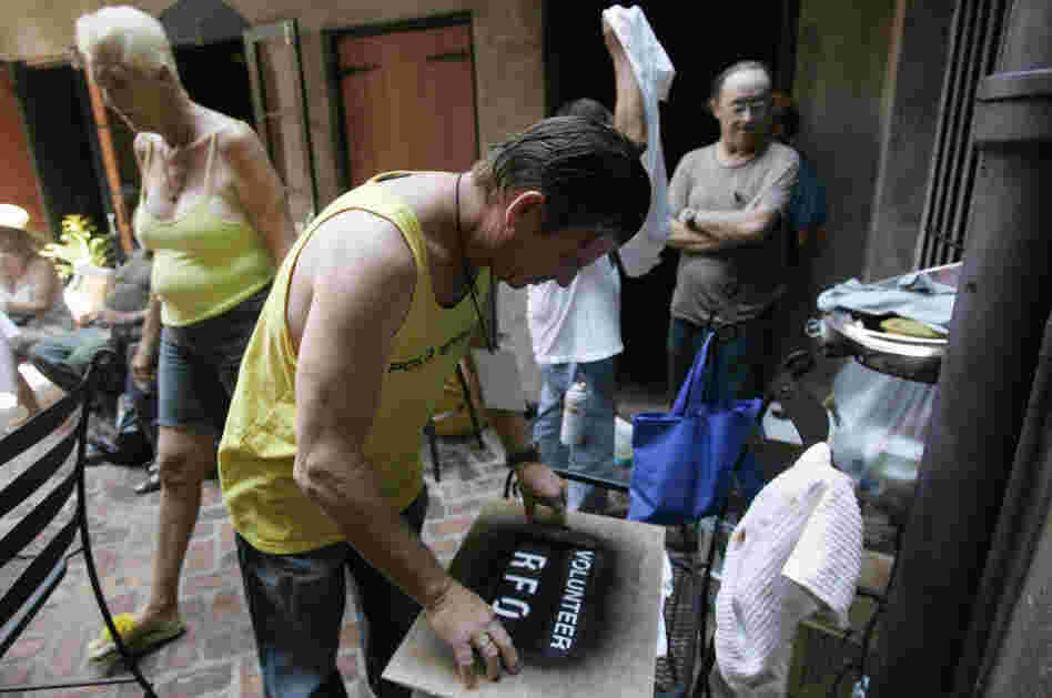 Residents of the Faubourg Marigny neighborhood of New Orleans printed T-shirts during a community meeting on Sept. 9, 2005. The neighborhood organized a cleanup effort even as mandatory evacuation of the city was under way. Refusing to obey the order to evacuate, many residents remained in their houses.