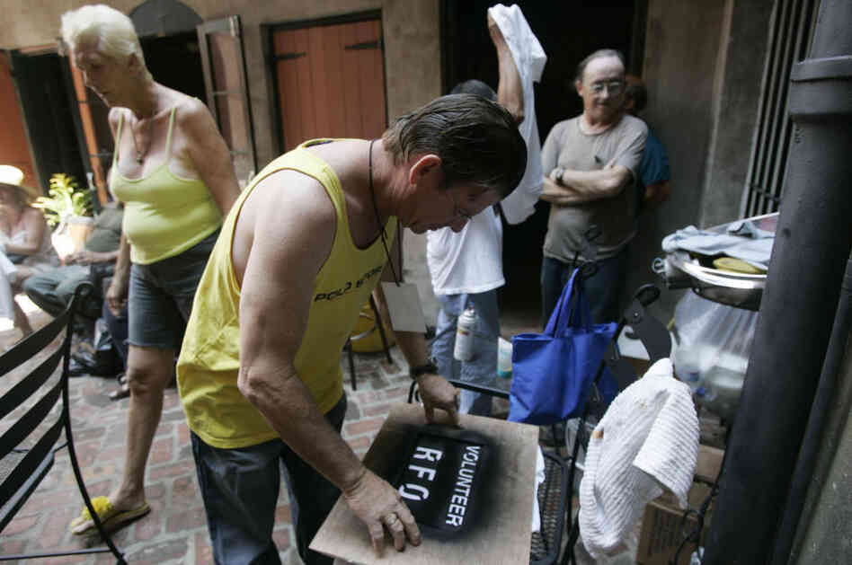 Residents of the Faubourg Marigny neighborhood of New Orleans printed T-shirts during a community meeting on Sept. 9, 2005. The neighborhood organized a cleanup effort even as mandatory evacuation of the city was under way. Refusing to obey the order to evacuate, many residents remained in their houses.
