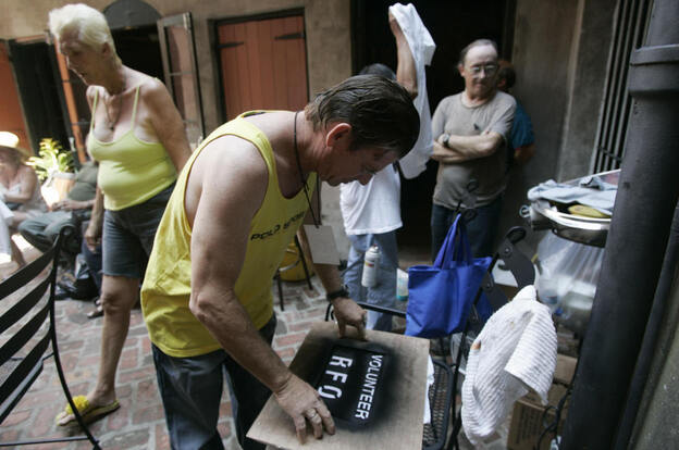 Residents of the Faubourg Marigny neighborhood of New Orleans printed T-shirts during a community meeting on Sept. 9, 2005. The neighborhood organized a cleanup effort even as mandatory evacuation of the city was under way. Refusing to obey the order to evacuate, many residents remained in their houses.