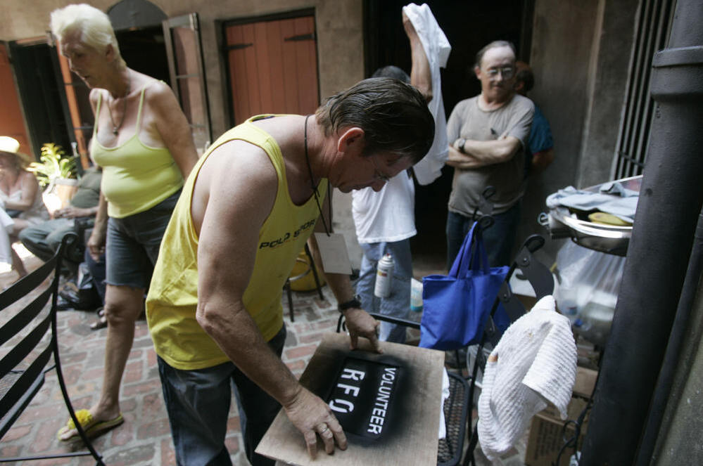 Residents of the Faubourg Marigny neighborhood of New Orleans printed T-shirts during a community meeting on Sept. 9, 2005. The neighborhood organized a cleanup effort even as mandatory evacuation of the city was under way. Refusing to obey the order to evacuate, many residents remained in their houses.