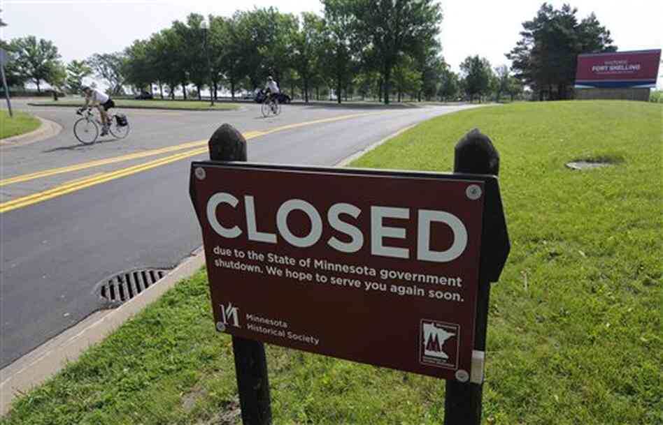 A bicyclist rides on the road leading out of the closed Fort Snelling historic site Friday in Minneapolis, after negotiations over the state budget broke down and the government shut down at midnight. A bicyclist rides on the road leading out of the closed Fort Snelling historic site Friday in Minneapolis, after negotiations over the state budget broke down and the government shut down at midnight.