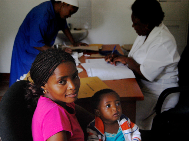 Lucrecia Silva and her daughter, Helena, are both HIV-positive. They wait as a nurse in Macia writes a prescription for Helena's anti-retroviral drugs.