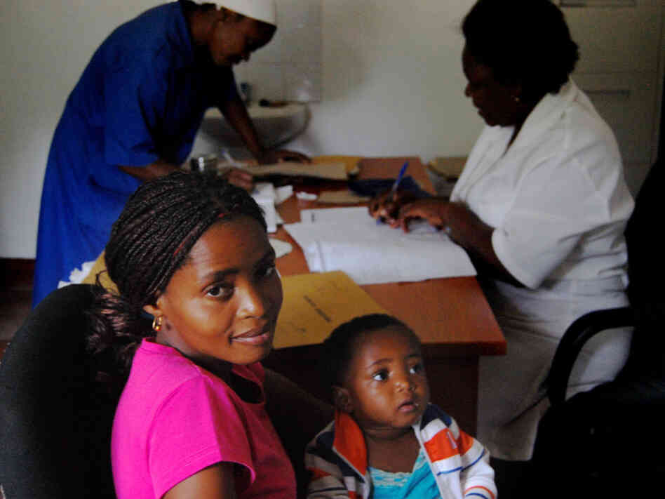 Lucrecia Silva and her daughter, Helena, are both HIV-positive. They wait as a nurse in Macia writes a prescription for Helena's anti-retroviral drugs.