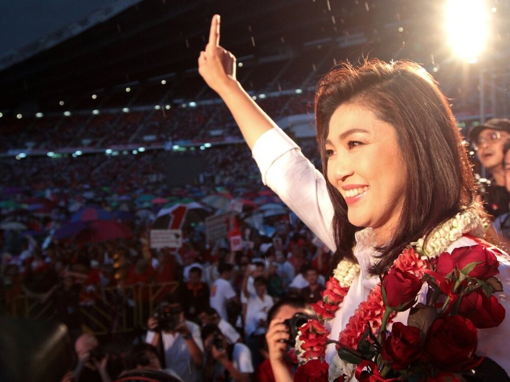 Yingluck gestures to her supporters during an election campaign at Rajamangala stadium in Bangkok on Friday.