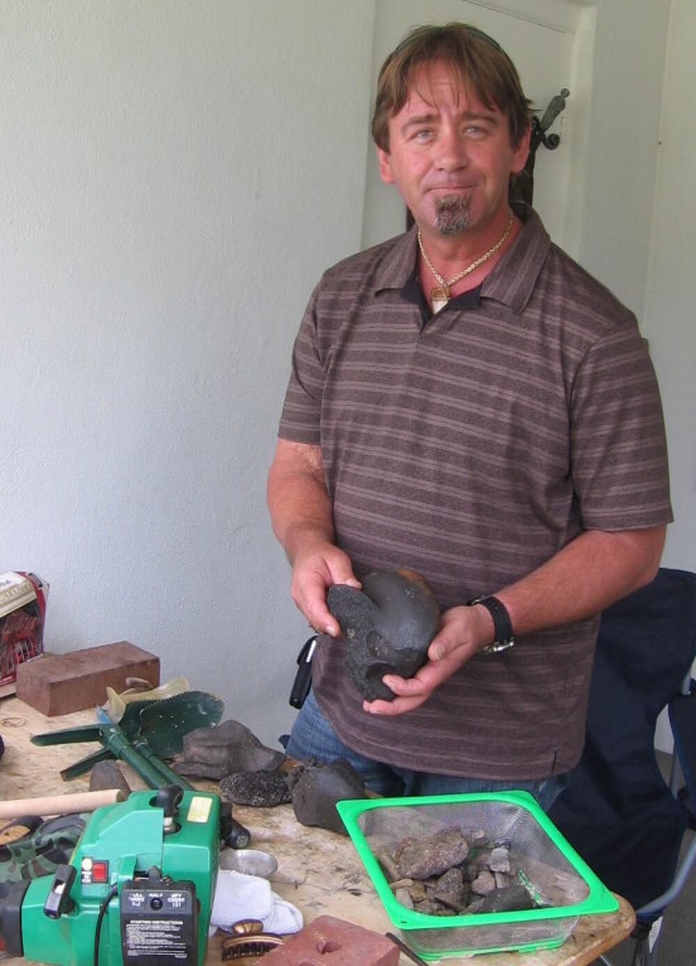 Amateur collector James Kennedy with some of the fossils he's collected in Florida. Kennedy found the carved bone four or five years ago, but didn't notice the carving until a few years later when he cleaned it.
