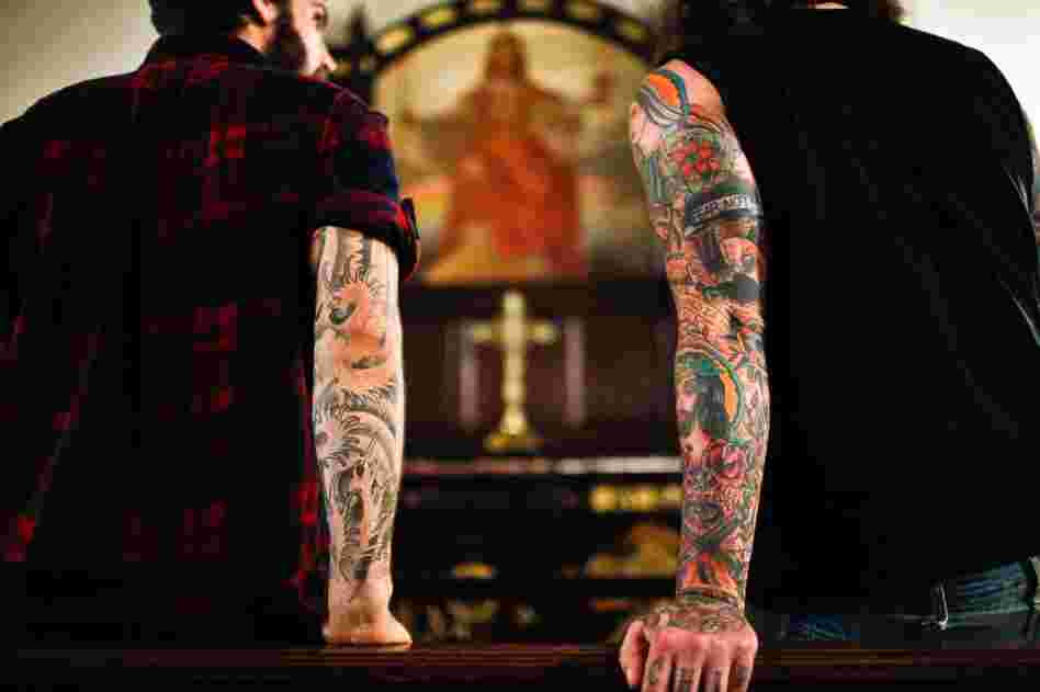 Lee Burford (right), drummer for The Body, and Zac Jones, drummer for Braveyoung, look at a painting in the St. Stephen's sanctuary.