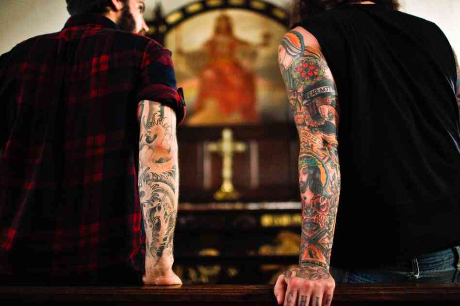 Lee Burford (right), drummer for The Body, and Zac Jones, drummer for Braveyoung, look at a painting in the St. Stephen's sanctuary.
