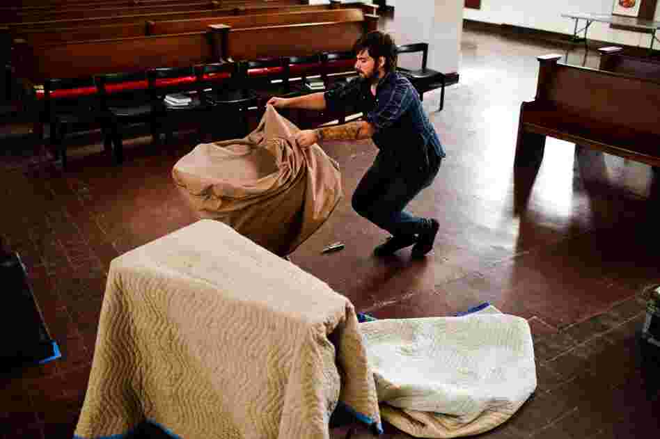 Isaac Jones, guitarist for Braveyoung, unpacks a tympani before the band's performance.