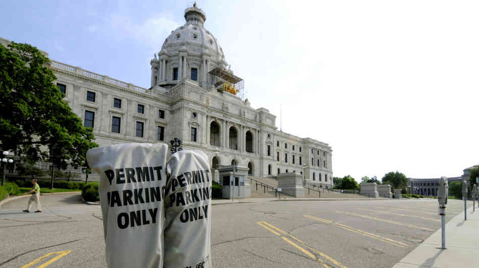 Lawmakers' parking spots were empty in front of the Minnesota Capitol in St. Paul on Friday.