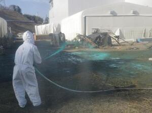 Workers at the Fukushima Dai-ichi nuclear power plant spray a substance to help reduce dust on April 1. Experts say it's likely that workers at the plant could have reduced the severity of the accident if they had made different decisions during the crisis.