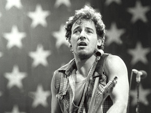 Bruce Springsteen, the NPR audience favorite, plays in front of the flag, circa 1984.