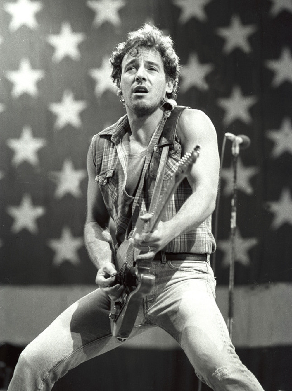 Bruce Springsteen, the NPR audience favorite, plays in front of the flag, circa 1984.