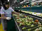 A worker inspects tomatoes at the West Coast Tomato plant in Palmetto, Fla. The Sunshine State produces one-third of all fresh tomatoes in the U.S.
