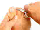 A man cutting his toenails. A man cutting his toenails.