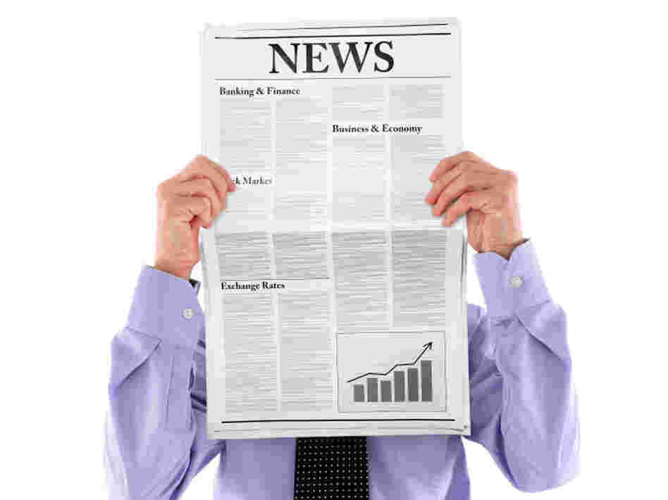Man hidden behind newspaper.