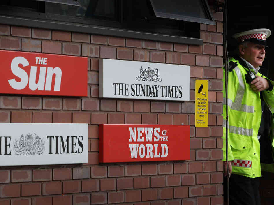 A policeman walks through the security gates at News International's wrapping plant on July 7 in London. A policeman walks through the security gates at News International's wrapping plant on July 7 in London.