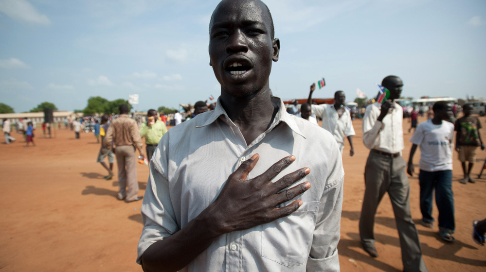 A South Sudanese man sings the new national anthem. In the recording below, students at Juba Commercial Secondary  School perform the song.