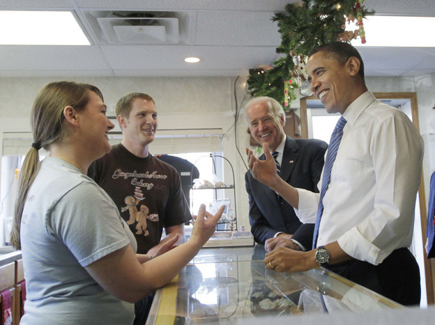 President Barack Obama, joined by Vice President Joe Biden, visit the Gingerbread House Bakery in downtown Kokomo, Ind., during a visit to tout the city as a success story of the Recovery Act in November 2010. Owners, Lauren Gaines and her husband Matt, left, received a $140,000 loan from the economic stimulus to buy the former doughnut shop.