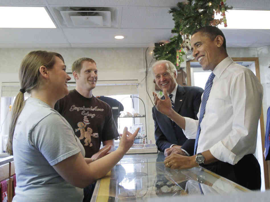 President Barack Obama, joined by Vice President Joe Biden, visit the Gingerbread House Bakery in downtown Kokomo, Ind., during a visit to tout the city as a success story of the Recovery Act in November 2010. Owners, Lauren Gaines and her husband Matt, left, received a $140,000 loan from the economic stimulus to buy the former doughnut shop.