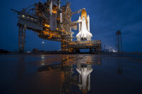 The night before the launch, Atlantis stands ready and waiting at Launchpad 39A at the Kennedy Space Center.