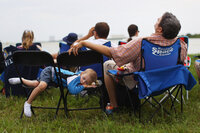 Zak Campbell (right) from San Diego, and his son Elijah sleep while awaiting the launch of space shuttle Atlantis in Cape Canaveral, Fla. It's the Campbells' first time attending a shuttle launch.