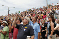 Spectators at the launch site catch a glimpse of history.