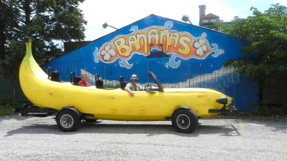 Steve Braithwaite sits in the driver's seat of his Big Banana Car in front of a closed nightclub in Allentown, Pa.