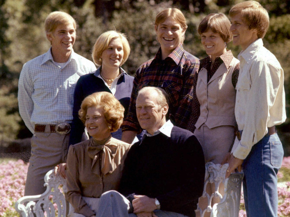 Members of the Ford family pose on the White House grounds in this undated photo. From left, standing: Son Steve; daughter Susan; son Jack; son Michael's wife, Gayle; and Michael. Seated in front: President Gerald and first lady Betty Ford.