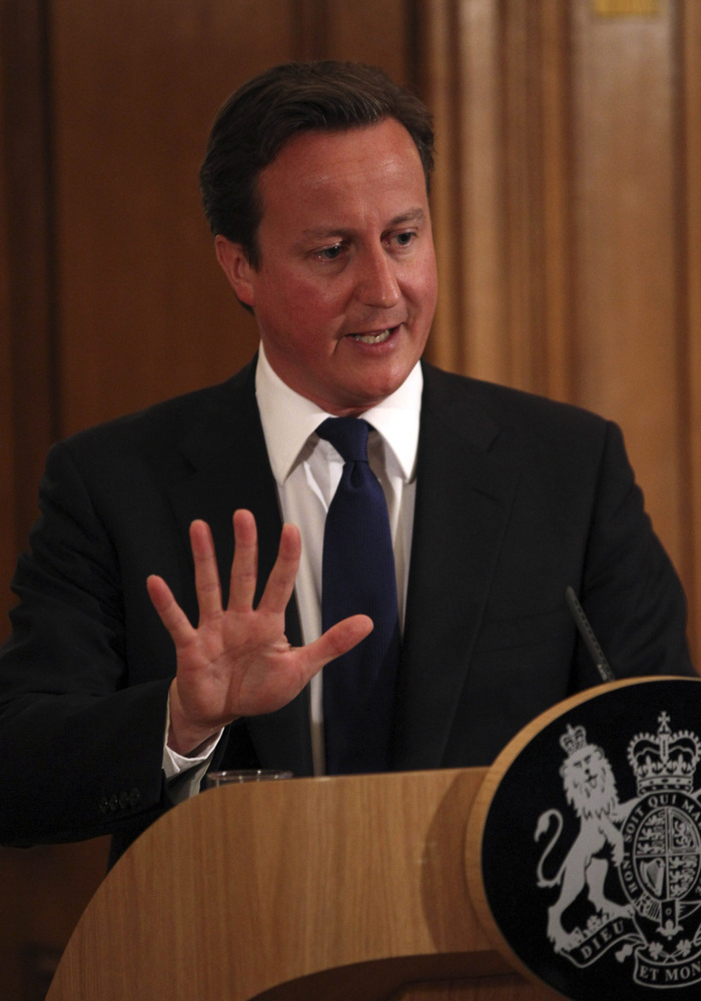 Britain's Prime Minister David Cameron promises a full investigation into the phone hacking and police bribery scandal that led to the collapse of the News of the World tabloid, at a press conference in London on Friday.