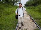 NPR reporter Jason Beaubien walks on railroad tracks while reporting a story about the dangers that face Central American migrants in Tenosique, Tabasco, Mexico. NPR reporter Jason Beaubien walks on railroad tracks while reporting a story about the dangers that face Central American migrants in Tenosique, Tabasco, Mexico.