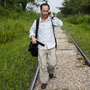 NPR reporter Jason Beaubien walks on railroad tracks while reporting a story about the dangers that face Central American migrants in Tenosique, Tabasco, Mexico. NPR reporter Jason Beaubien walks on railroad tracks while reporting a story about the dangers that face Central American migrants in Tenosique, Tabasco, Mexico.