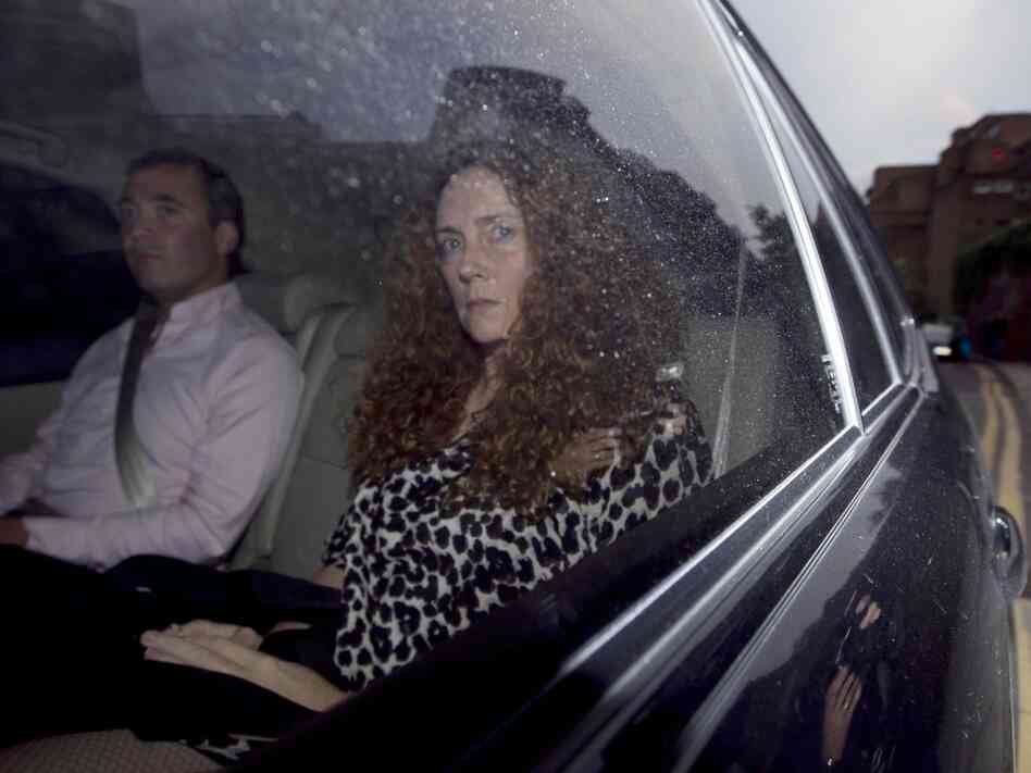 Rebekah Brooks, chief executive of News International, is driven away from her office in London on Thursday. That's the day the company announced it is shutting down News of the World, which is the best-selling tabloid at the center of Britain's phone-hacking scandal. The 168-year-old weekly newspaper will publish its last edition Sunday.