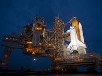 Stormy weather may still force a postponement of the launch to Saturday.