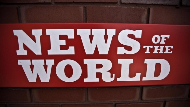 A News of the World sign is posted by an entrance of its parent company in London. News Corp. executive James Murdoch announced Thursday that News of the World will publish its last issue Sunday. A phone-hacking scandal has cost the weekly paper prestige and prompted dozens of companies to pull their ads.