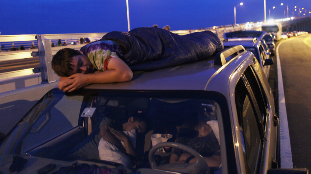Spur King from Armarillo, Texas, slept on the roof of a van in Titusville, Fla., as he waited earlier today for, he hopes, the launch of Atlantis.