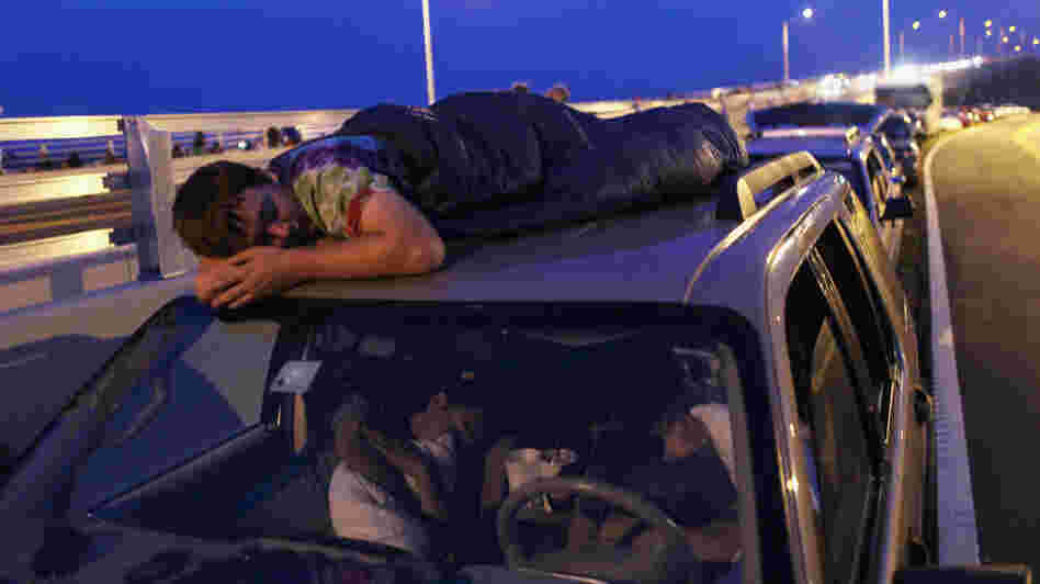 Spur King from Armarillo, Texas, slept on the roof of a van in Titusville, Fla., as he waited earlier today for, he hopes, the launch of Atlantis.