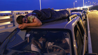 Spur King from Armarillo, Texas, slept on the roof of a van in Titusville, Fla., as he waited earlier today for, he hopes, the launch of Atlantis.