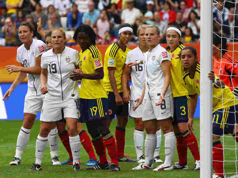 U.S. players, in white, line up for a corner kick against Colombia in a group stage game of the 2011 Women's World Cup. The white jerseys have been criticized as resembling a nurse's uniform.