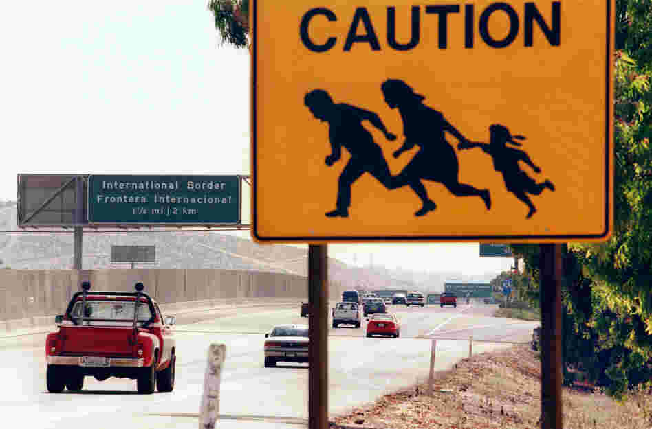 A 1997 photo shows a sign in San Diego, Calif., warning drivers about pedestrians running across the highway at the U.S.-Mexico border. St. John says that seeing borders as tools to control the movement of people is a uniquely 20th-century phenomenon.