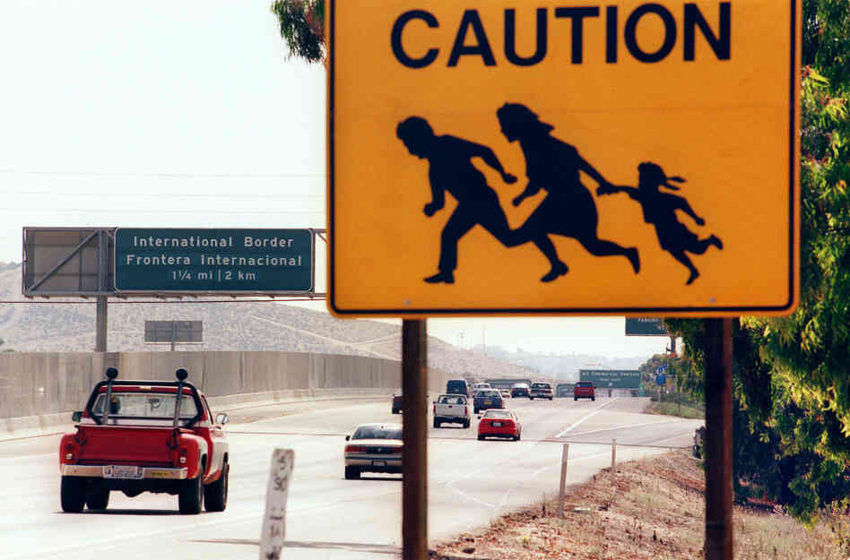 A 1997 photo shows a sign in San Diego, Calif., warning drivers about pedestrians running across the highway at the U.S.-Mexico border. St. John says that seeing borders as tools to control the movement of people is a uniquely 20th-century phenomenon.