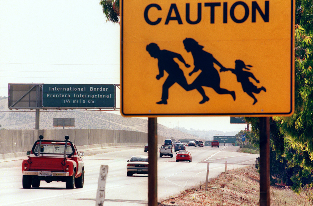 A 1997 photo shows a sign in San Diego, Calif., warning drivers about pedestrians running across the highway at the U.S.-Mexico border. St. John says that seeing borders as tools to control the movement of people is a uniquely 20th-century phenomenon.