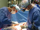 Surgical fellow Pablo Laje (left) and Dr. Scott Adzick finish prenatal surgery on Sarah White. Her fetus has spina bifida — a hole in the lower back that exposes the spinal cord. Surgical fellow Pablo Laje (left) and Dr. Scott Adzick finish prenatal surgery on Sarah White. Her fetus has spina bifida — a hole in the lower back that exposes the spinal cord.