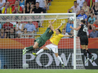 U.S. forward Abby Wambach heads in the equalizer past Brazil's defender Daiane and goalkeeper Andreia Sunday in Dresden. U.S. forward Abby Wambach heads in the equalizer past Brazil's defender Daiane and goalkeeper Andreia Sunday in Dresden.