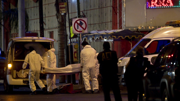 Forensic workers load a truck with bodies after gunmen opened fire in a nightclub in Monterrey, Mexico, Friday July 8, 2011. Forensic workers load a truck with bodies after gunmen opened fire in a nightclub in Monterrey, Mexico, Friday July 8, 2011.
