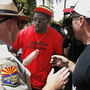 A police officer (left) tries to keep the peace as immigrant rights protester Bobby DeVeaux (middle) and Tea Party supporter David Jones argue amid 450 immigrant rights protesters marching on the Arizona Capitol last spring.