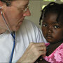 Paul Farmer examines a child at a mobile clinic in Haiti. Paul Farmer examines a child at a mobile clinic in Haiti.