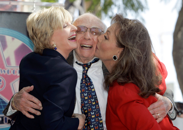 Writer/producer Sherwood Schwartz receives a kiss from actresses Florence Henderson, left, and Dawn Wells during a 2008 ceremony where Schwartz was honored with a star on the Hollywood Walk of Fame in Los Angeles.