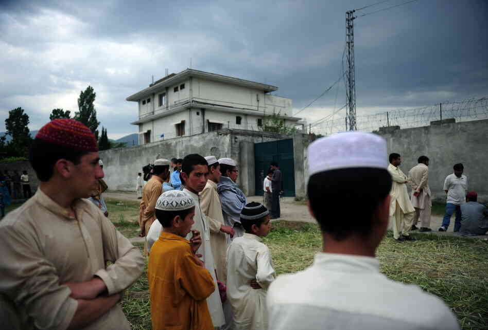 Pakistanis gather in front of the compound where Al-Qaida chief Osama bin Laden was killed in Abbottabad.