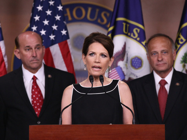 Rep. Michele Bachmann speaks while fellow Republicans representatives Louie Gohmert of Texas (l) and Steve King of Iowa wait.